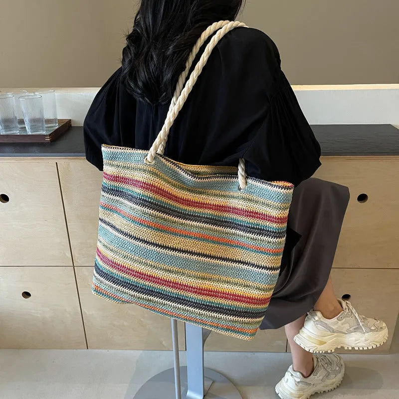 Blue woven nylon shoulder bag with straw-weave pattern and adjustable strap