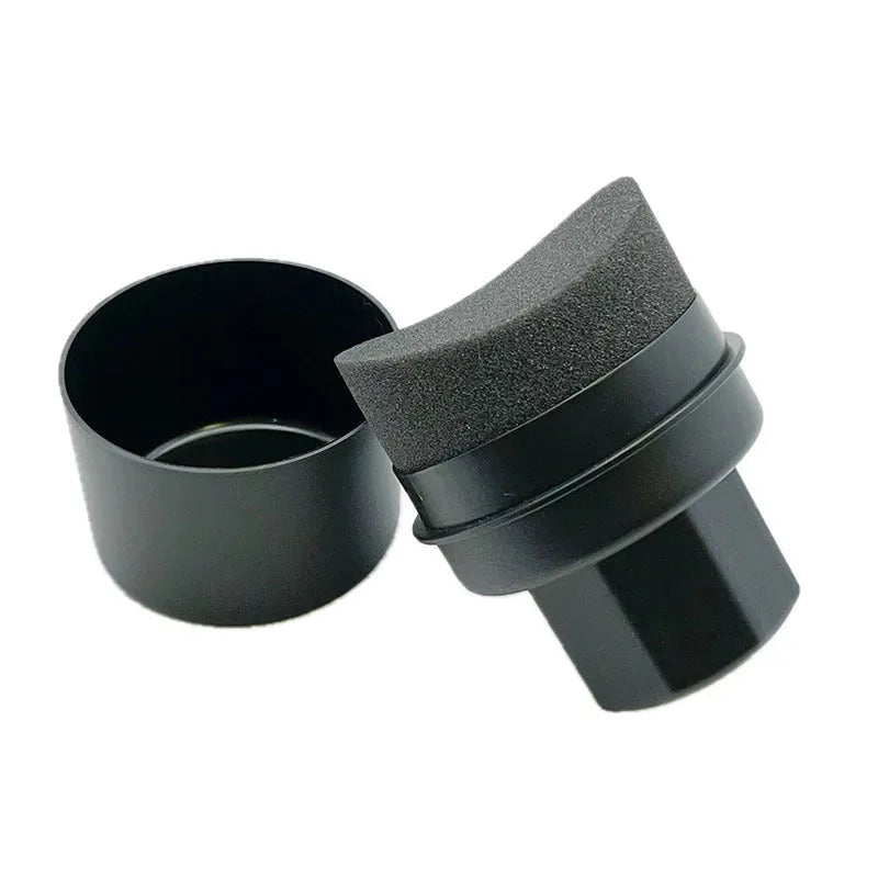 Black car tyre polishing sponge brush with a red lid, showing its size next to a car tyre.