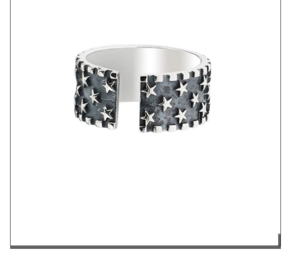 Adjustable open-back sterling silver ring with a geometric five-pointed star pattern.