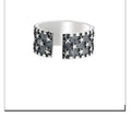 Adjustable open-back sterling silver ring with a geometric five-pointed star pattern.