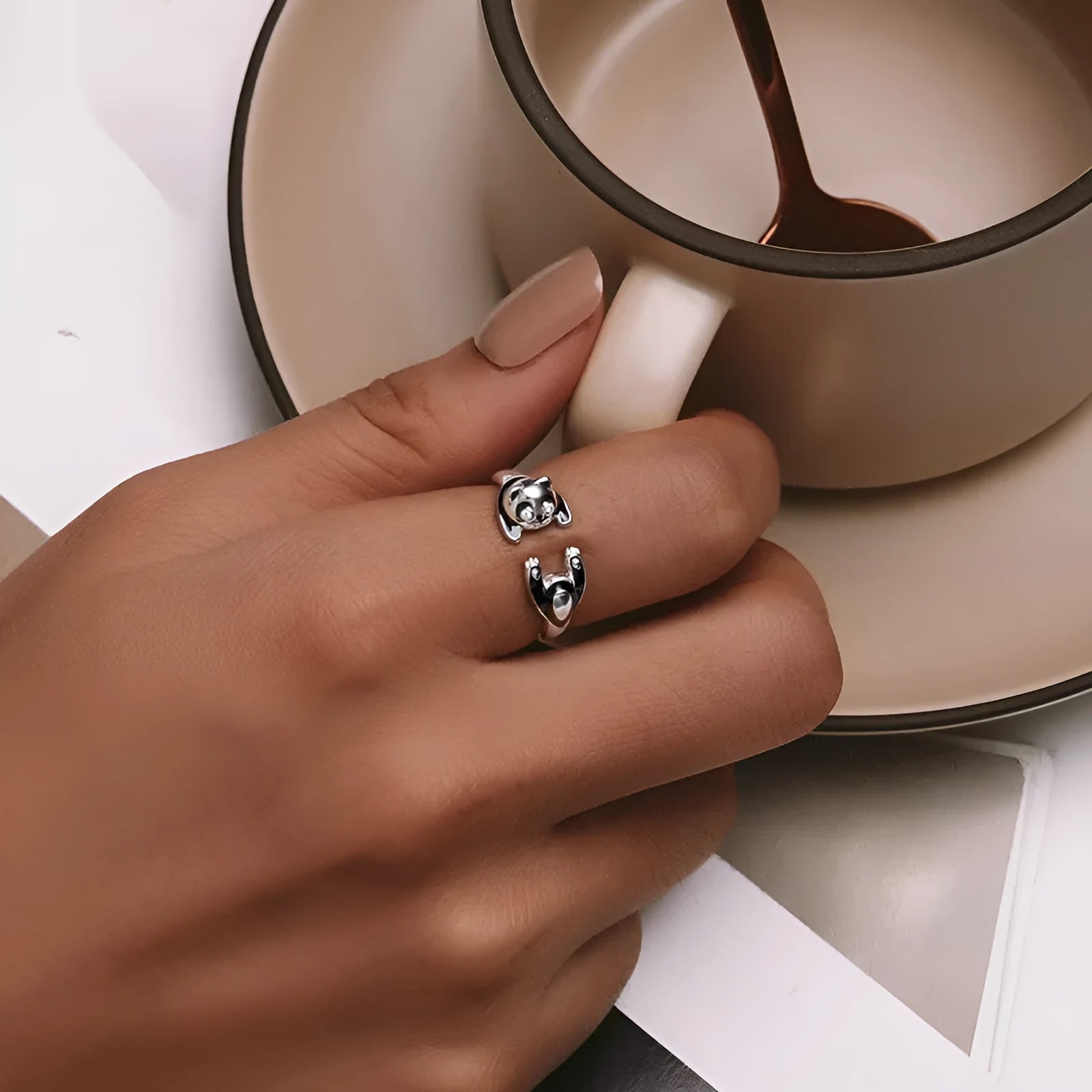 Cute Panda adjustable open ring in sterling silver with white gold plating on a finger.