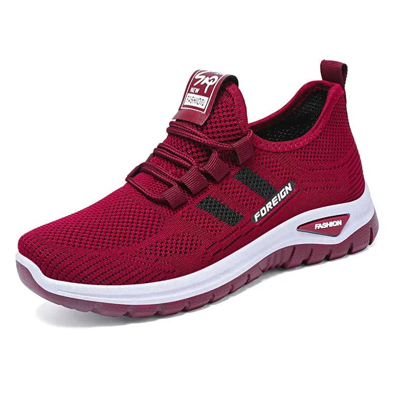 Women's low-top casual sneakers in black with breathable mesh upper and flat PVC sole
