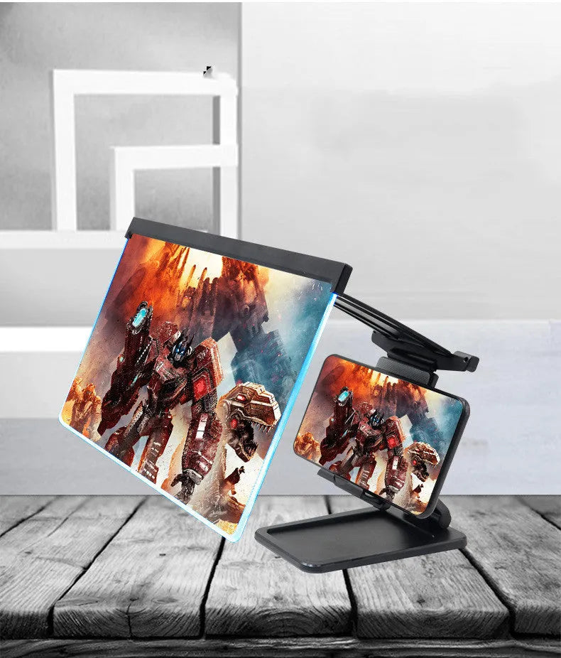 Black folding mobile phone screen magnifier and detachable phone holder on a desk.