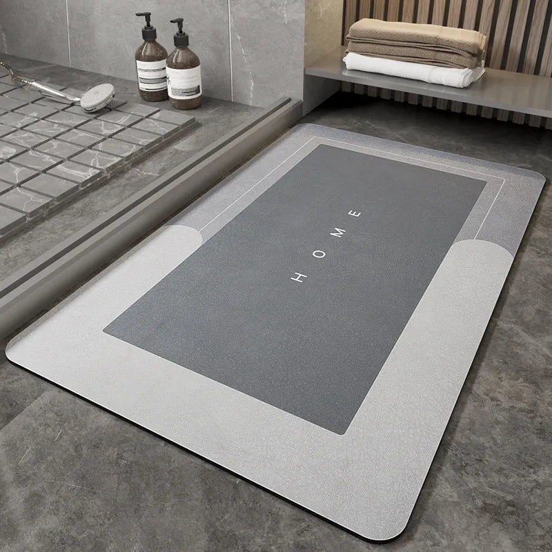 Machine-woven blended bathroom floor mat in blue, shown in an oval shape on a tiled floor.
