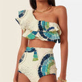 White one-shoulder women's swimsuit with a large layered lotus leaf skirt and split-leg design.