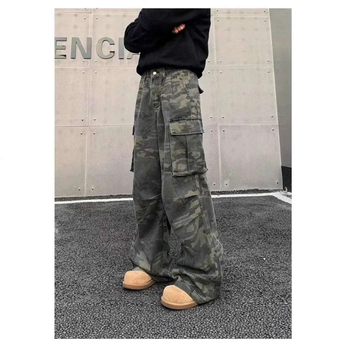Men's loose-fit camouflage cargo pants with multiple pockets on a washed vintage-style fabric.