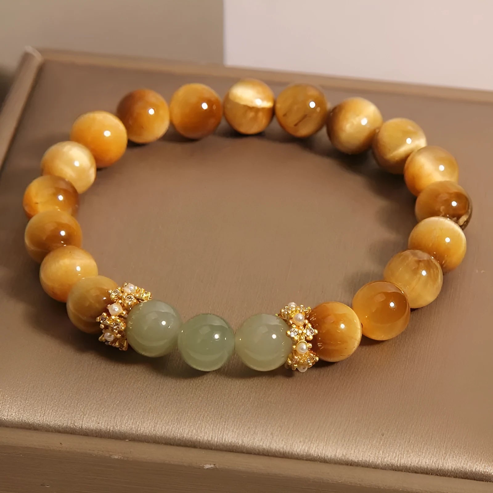 Natural yellow tiger's eye stone bracelet showing golden gourd, bamboo joint, and lace pattern variations