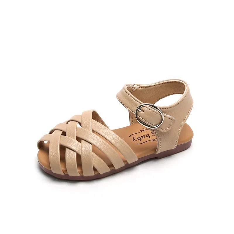 Kids buckle-toe soft sole woven sandals in white, black, and pink on a light background