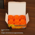 Set of six plastic pumpkin-coloured Halloween electric candle lamps in European style on a dark background