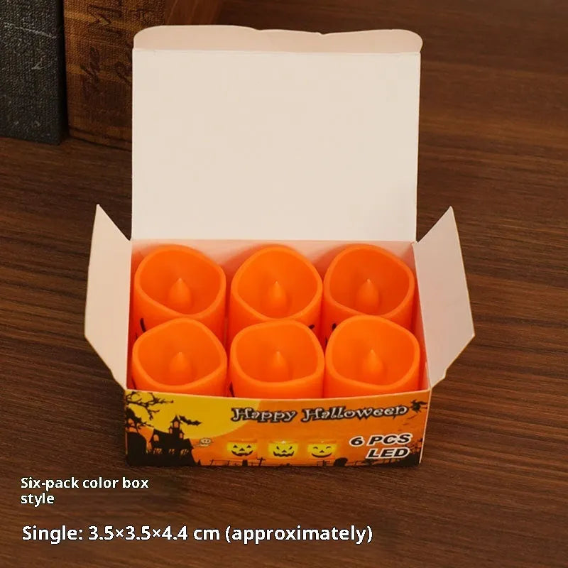 Set of six plastic pumpkin-coloured Halloween electric candle lamps in European style on a dark background