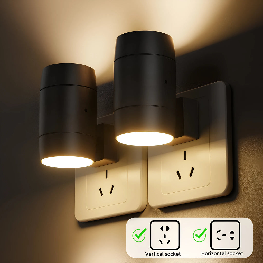 A small white plug-in night light with an adjustable head, shown next to a power socket for scale.