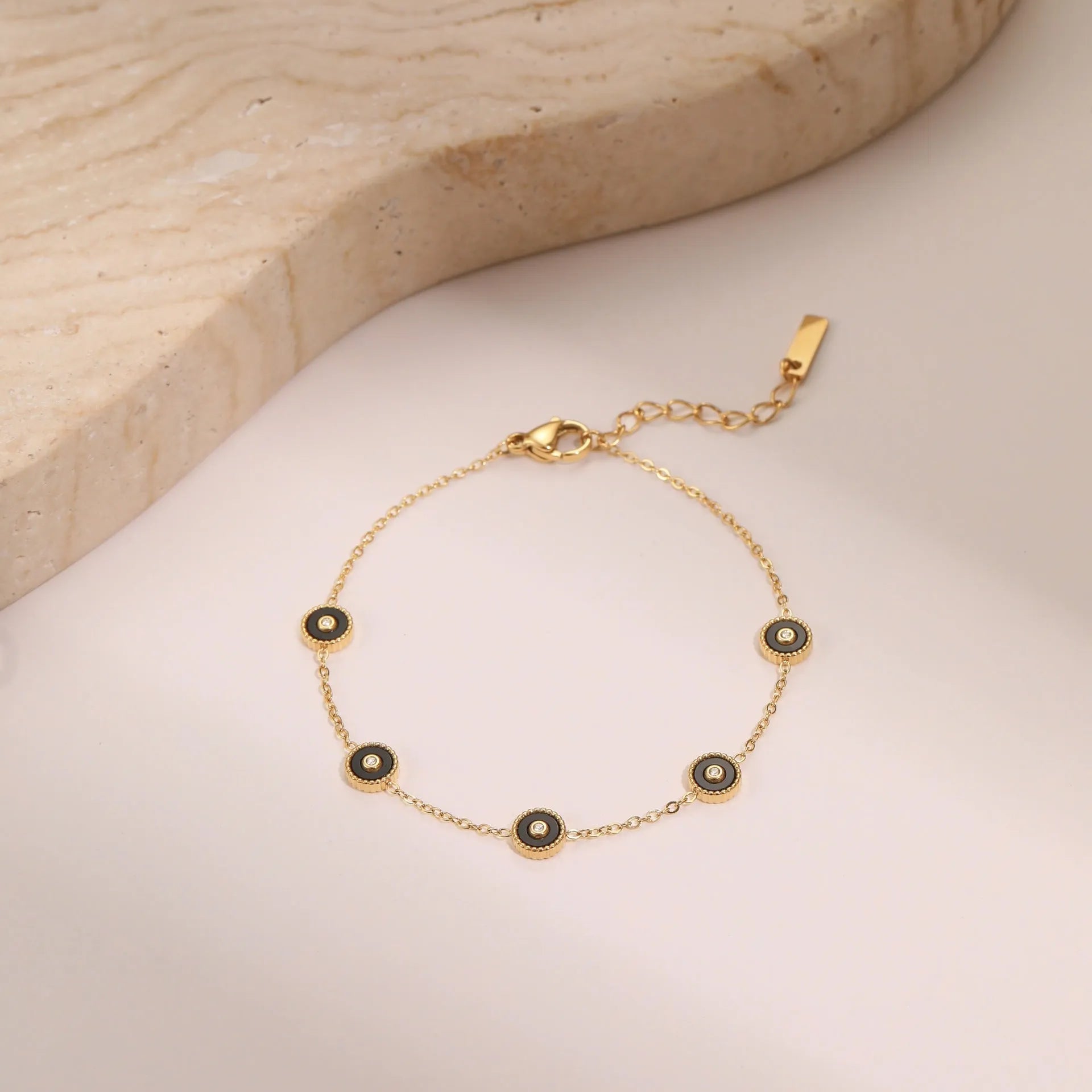Gold-plated geometric fritillary design stainless steel bracelet and necklace set for women.