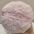 Large rectangular plush powder puff for makeup application in pink, white, or skin colour.