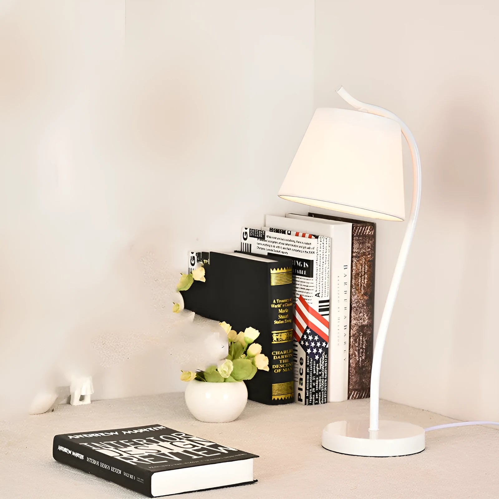 A simple modern Nordic style LED desk lamp with a dimmer switch on a desk.