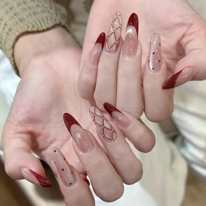 Set of medium-length coffin-shaped false nails with French manicure glitter tips and rhinestone decorations.