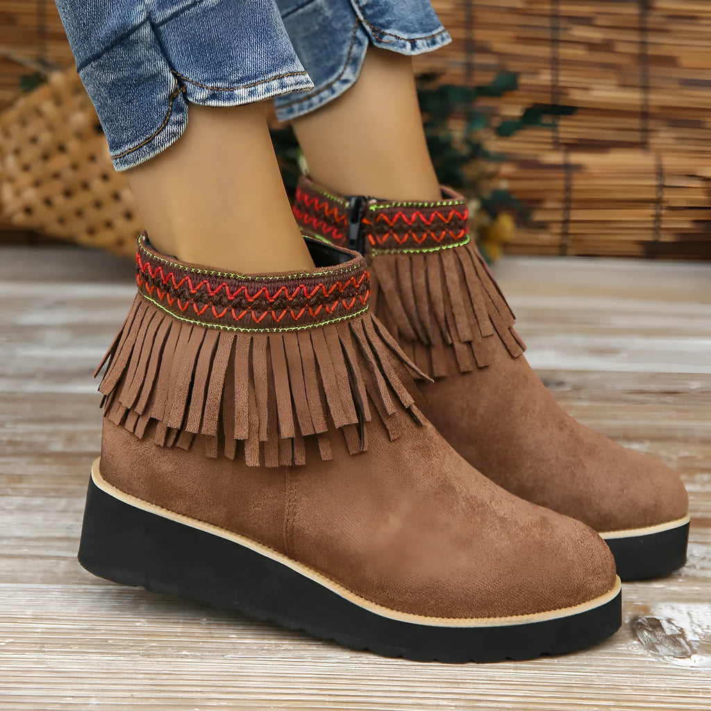 Women's suede wedge ankle boot with tassel detail, side zip, and a thick rubber sole.