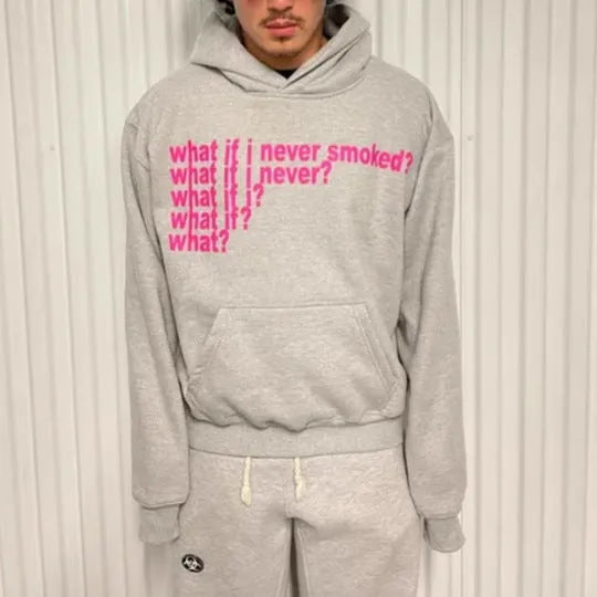 Black and grey heavy hooded sweater with printed letter graphics, showing front view with hood up