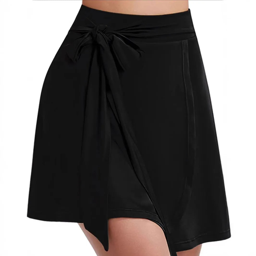 Black thigh-length sports culotte skirt with built-in shorts and an adjustable shoulder strap