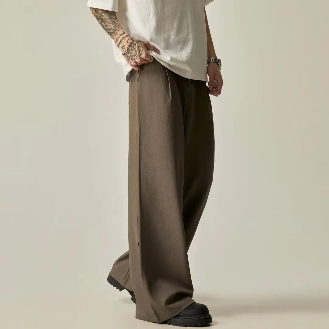 Men's solid black wide-leg casual trousers with a vertical tube cut and button fly.