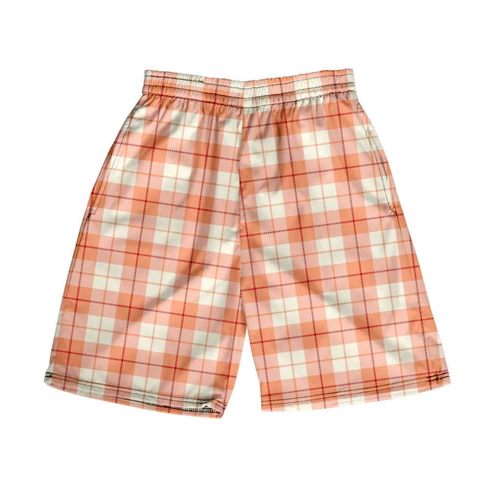 Man wearing straight-leg plaid shorts with an elastic waistband on a beach, showing one of twenty available colour variations.