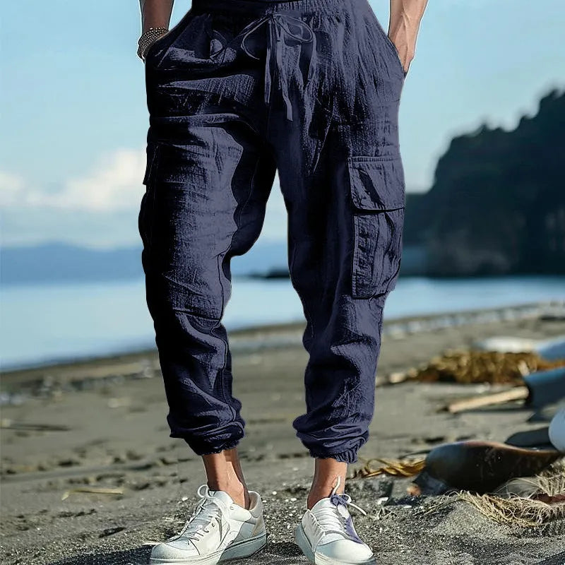 Men's linen casual trousers with ankle-tied cuffs and multiple pockets in a solid colour.
