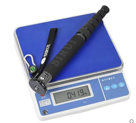 Black carbon fibre six-section SLR camera monopod extended to its maximum height.