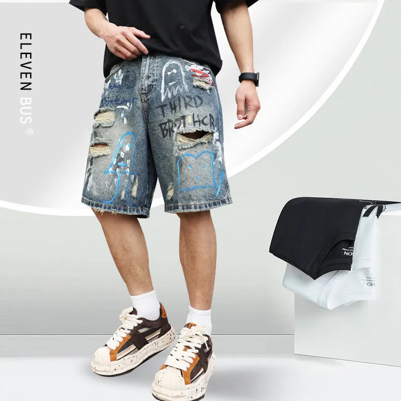 Men's blue ripped jeans shorts with straight leg cut, zipper fly, and graffiti detailing