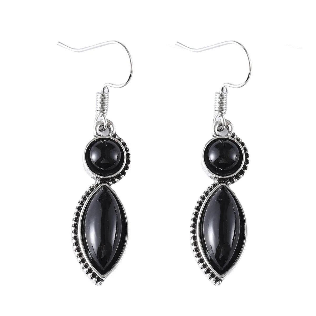 Close-up of vintage black and purple geometric drop earrings with a circular pendant on a long chain.