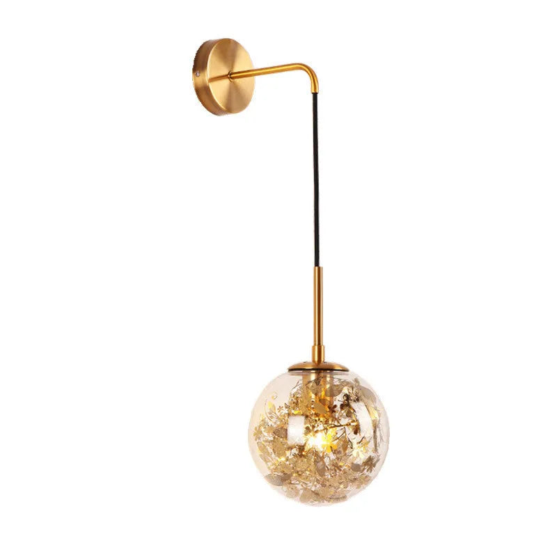 Modern golden flower glass wall lamp mounted beside a bed.