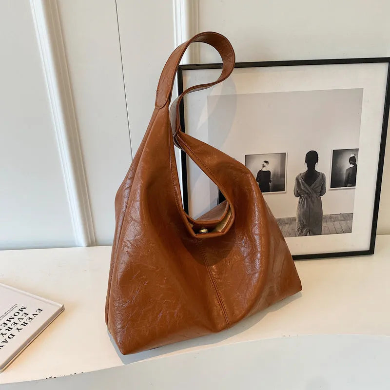 Soft PU leather large capacity shoulder bag in black with a sandwich pocket and contrasting stitching.