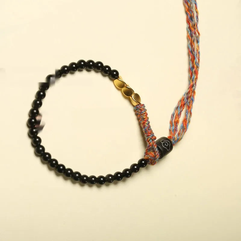 Hand-woven obsidian carrying strap bracelet showing textured surface and adjustable 15.5-16cm length