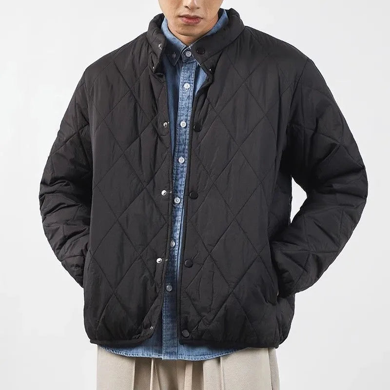 Men's black diamond lattice quilted winter jacket with a loose, longline fit on a hanger.