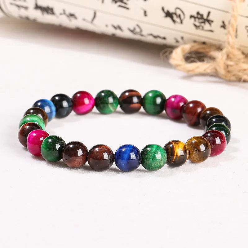 Colourful tiger's eye natural stone bracelet with round beads on a string lace, shown in unisex design.