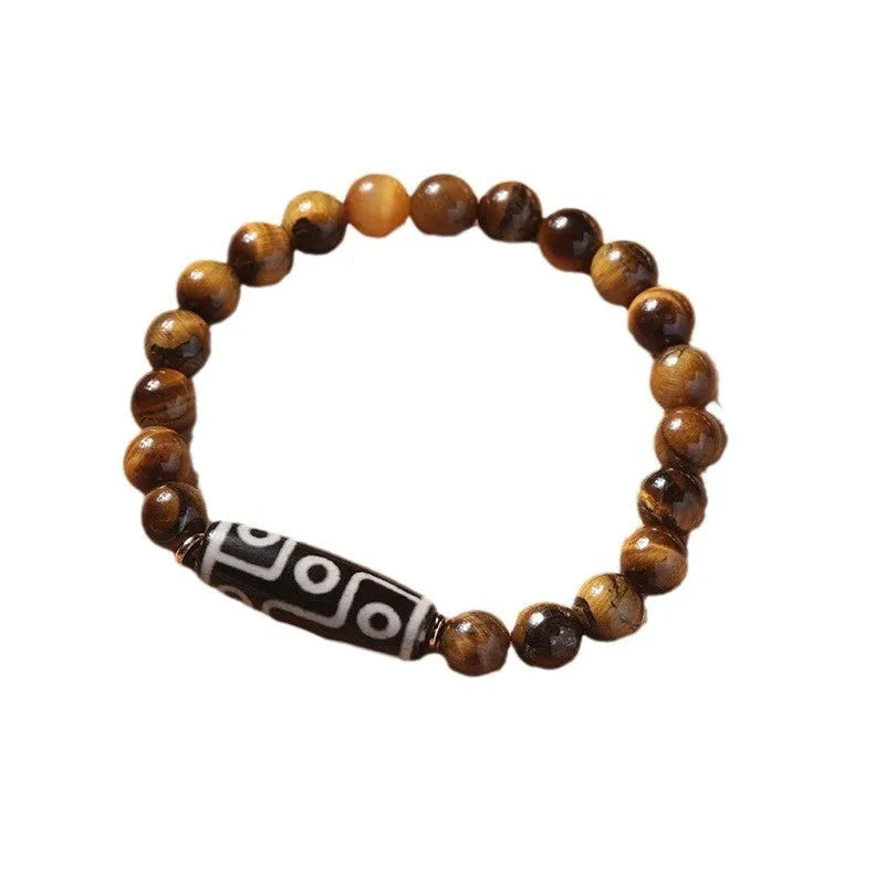 Single circle ethnic Tigereye bead Buddha rosary bracelet on a wrist, showing unisex design.