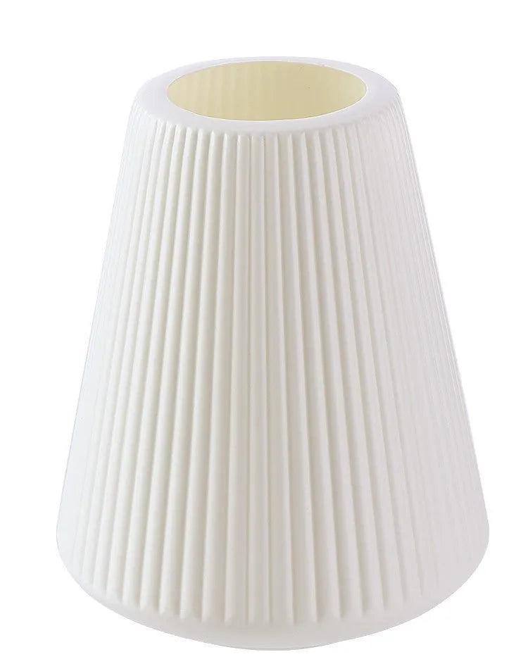 Colourful melamine plastic flower vase in blue, green, pink, or white on a desk.
