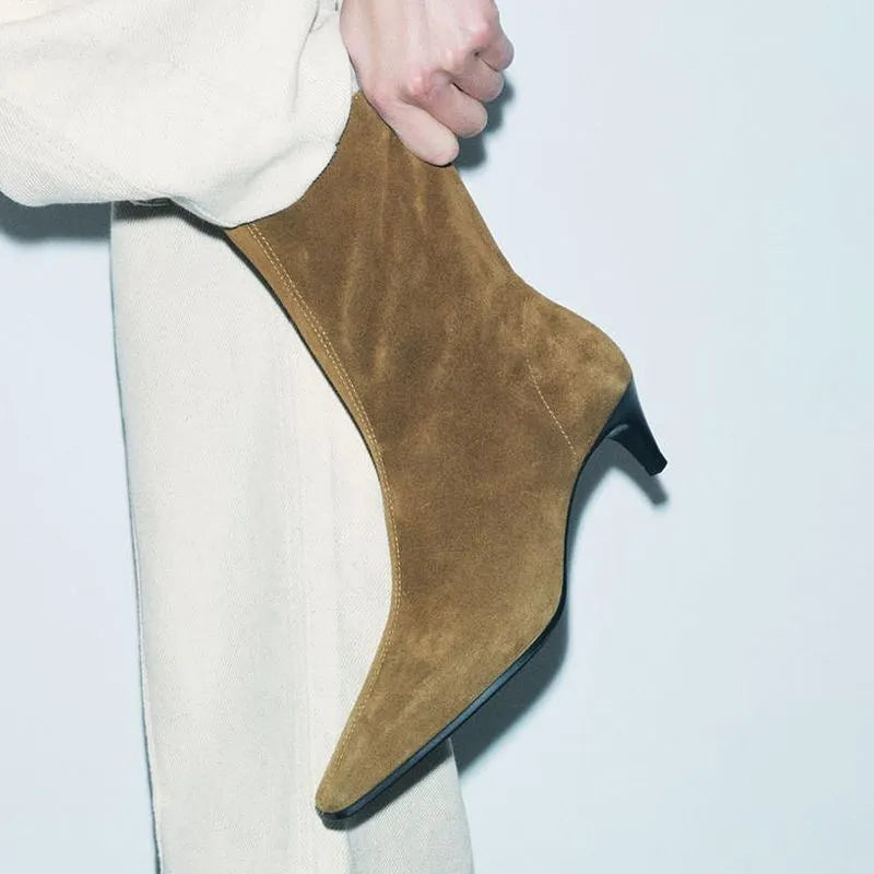 Brown square toe women's ankle boot with a side zip and a mid kitten heel on a plain background.