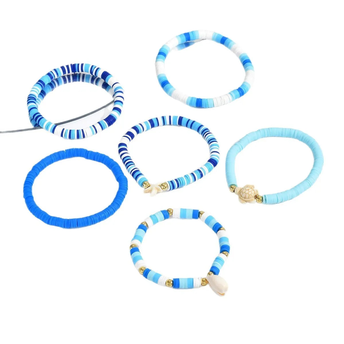 Set of six handmade bohemian polymer clay bracelets with shell and geometric designs in S3162 colour.