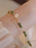 Handmade olivine bracelet with double layer Twin Bells of Ireland design on adjustable string cord