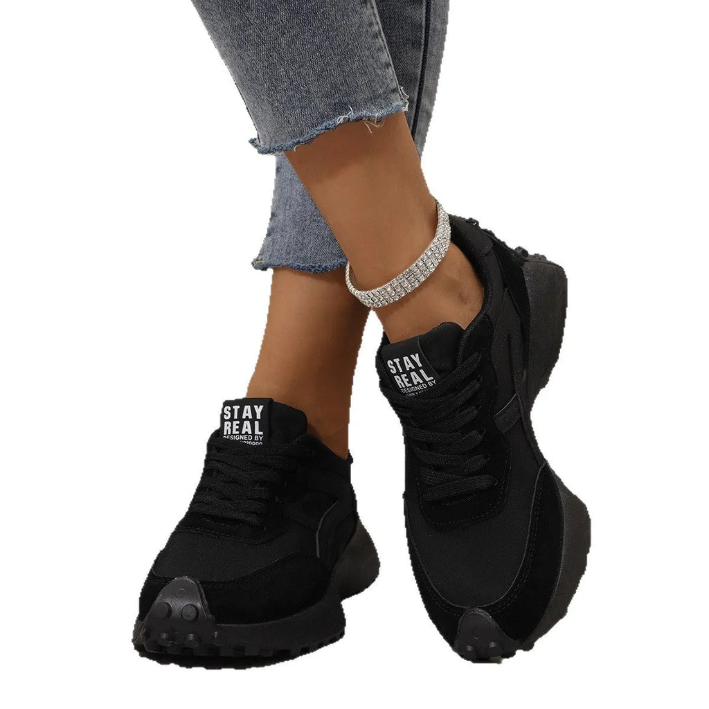 Black mesh sports flat shoes for women with synthetic leather upper and rubber sole, side view