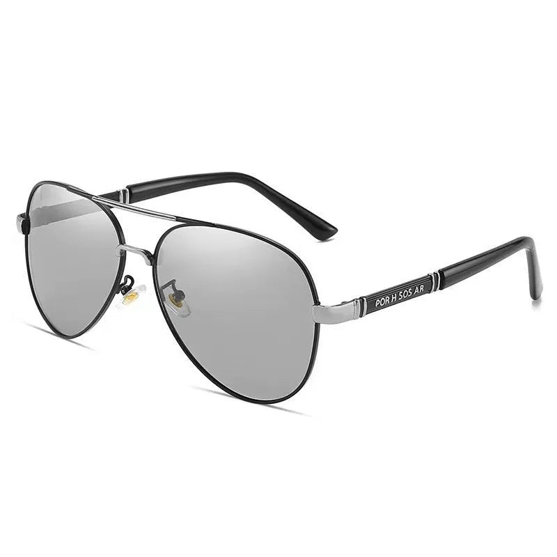 Gold metal frame polarised sunglasses with grey lenses on a table, showing dragon and phoenix temple detail.
