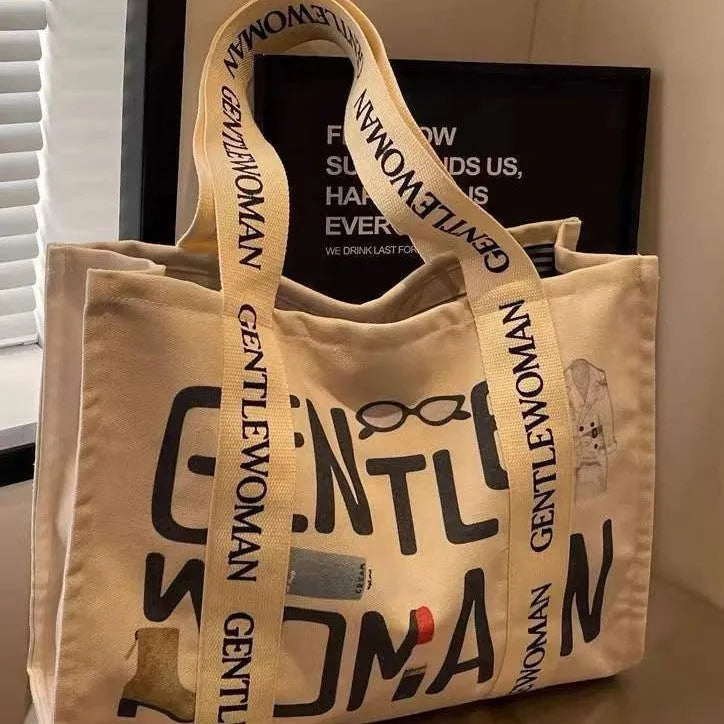 Large canvas women's tote bag with printed design, shown in available colour options.
