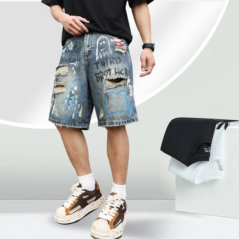 Men's blue ripped jeans shorts with straight leg cut, zipper fly, and graffiti detailing