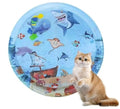 Blue circular cat water playmat on floor, showing ocean fish design and floating fish toys inside.