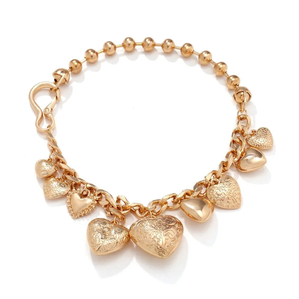 Gold exaggerated carved heart pendant necklace on model, showing adjustable metal chain.