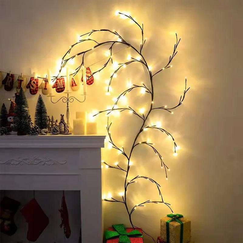 Flexible plastic LED willow vine garland with warm white lights bent into a decorative shape on a wall.