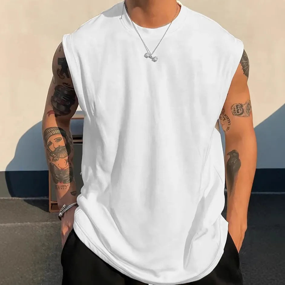 Men's loose solid colour cotton tank top on a hanger, showing straight hem and sleeveless design.