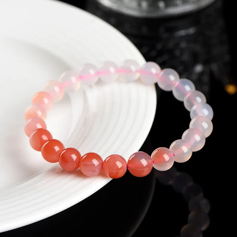 Natural gradient salt source colour Yanyuan agate bracelet with geometric beads on a wrist.