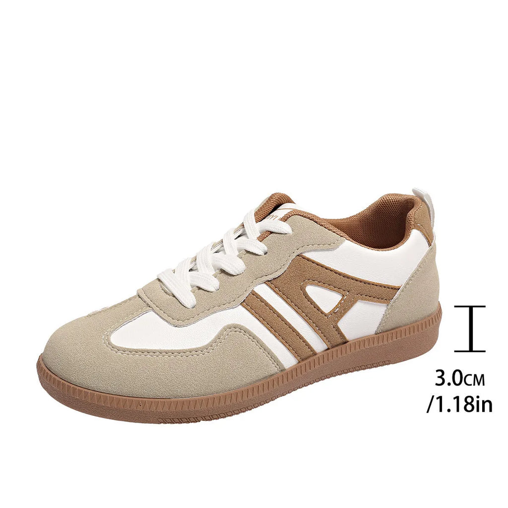 Retro lace-up women's jogging shoes in grey with a platform heel and cross strap detail.
