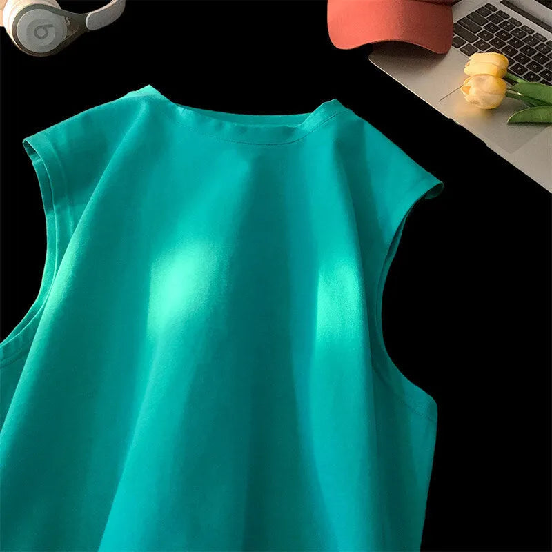 Men's loose solid colour cotton tank top on a hanger, showing straight hem and sleeveless design.