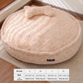 Small milk tea coloured fabric dog kennel with a round nest design on a wooden floor.